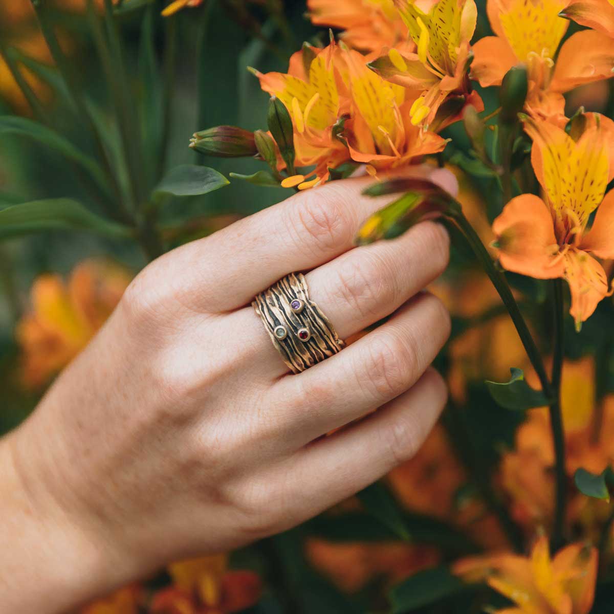 girl wearing brave love birthstone ring handcrafted in 10k yellow gold customizable with up to five 2mm genuine birthstones