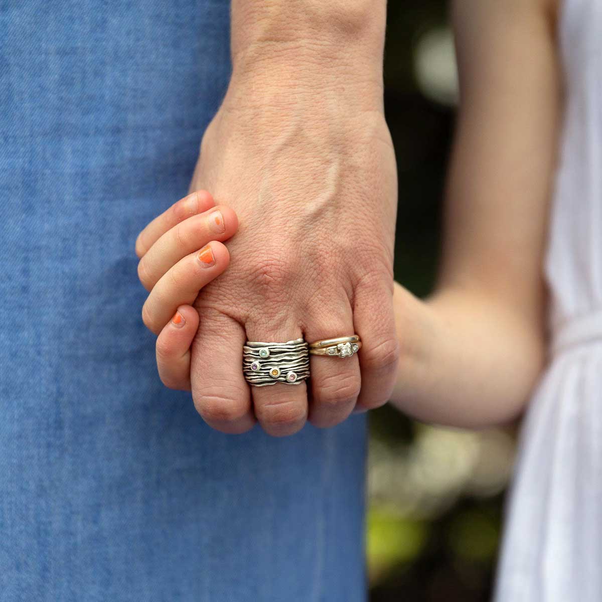 woman wearing brave love birthstone ring handcrafted in sterling silver customizable with up to five 2mm genuine birthstones