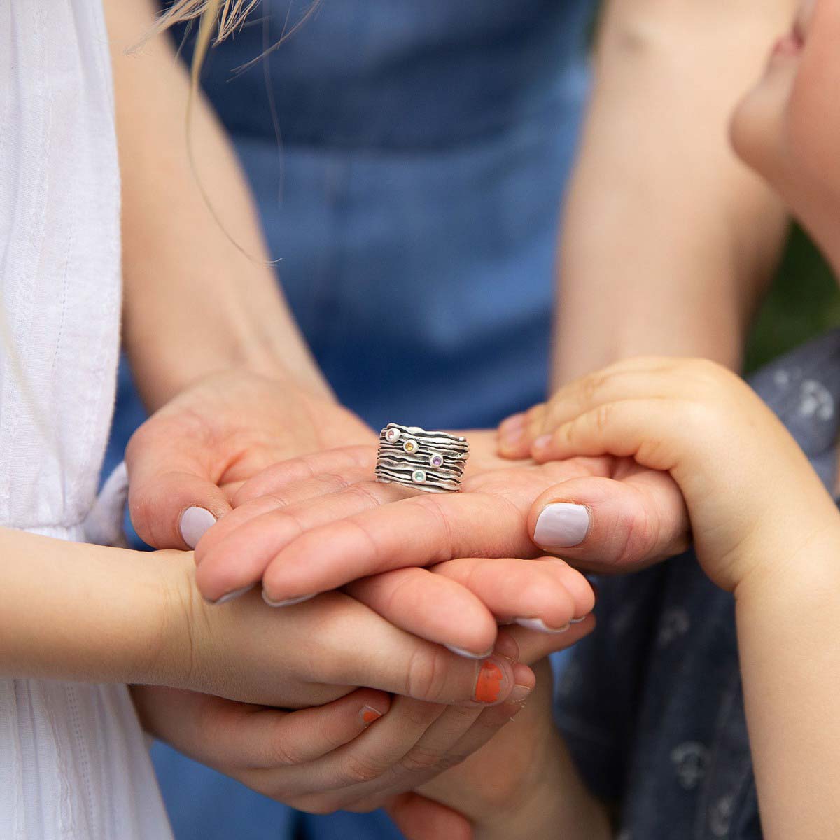 woman wearing brave love birthstone ring handcrafted in sterling silver customizable with up to five 2mm genuine birthstones