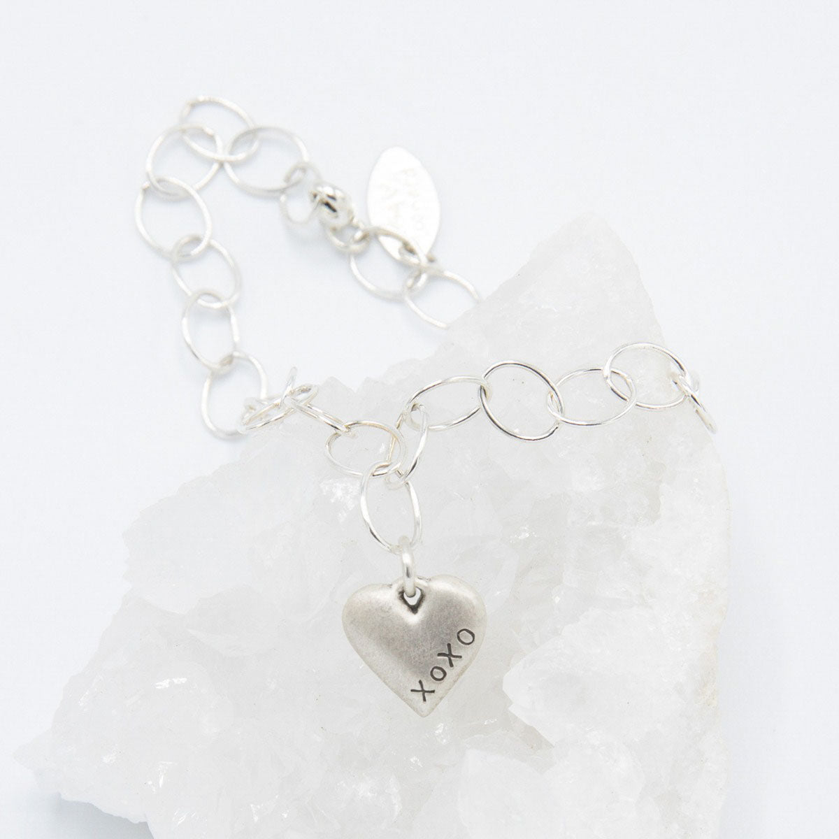 Handcrafted sterling silver Brave Love emblem bracelet with a matte brushed finish