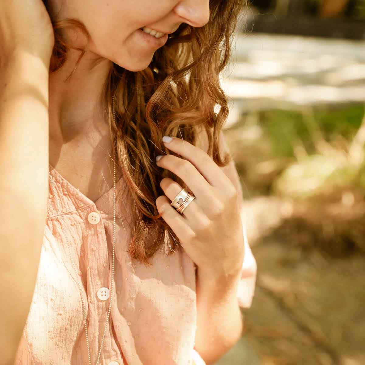 girl wearing brave love® spinner ring {sterling silver & bronze}