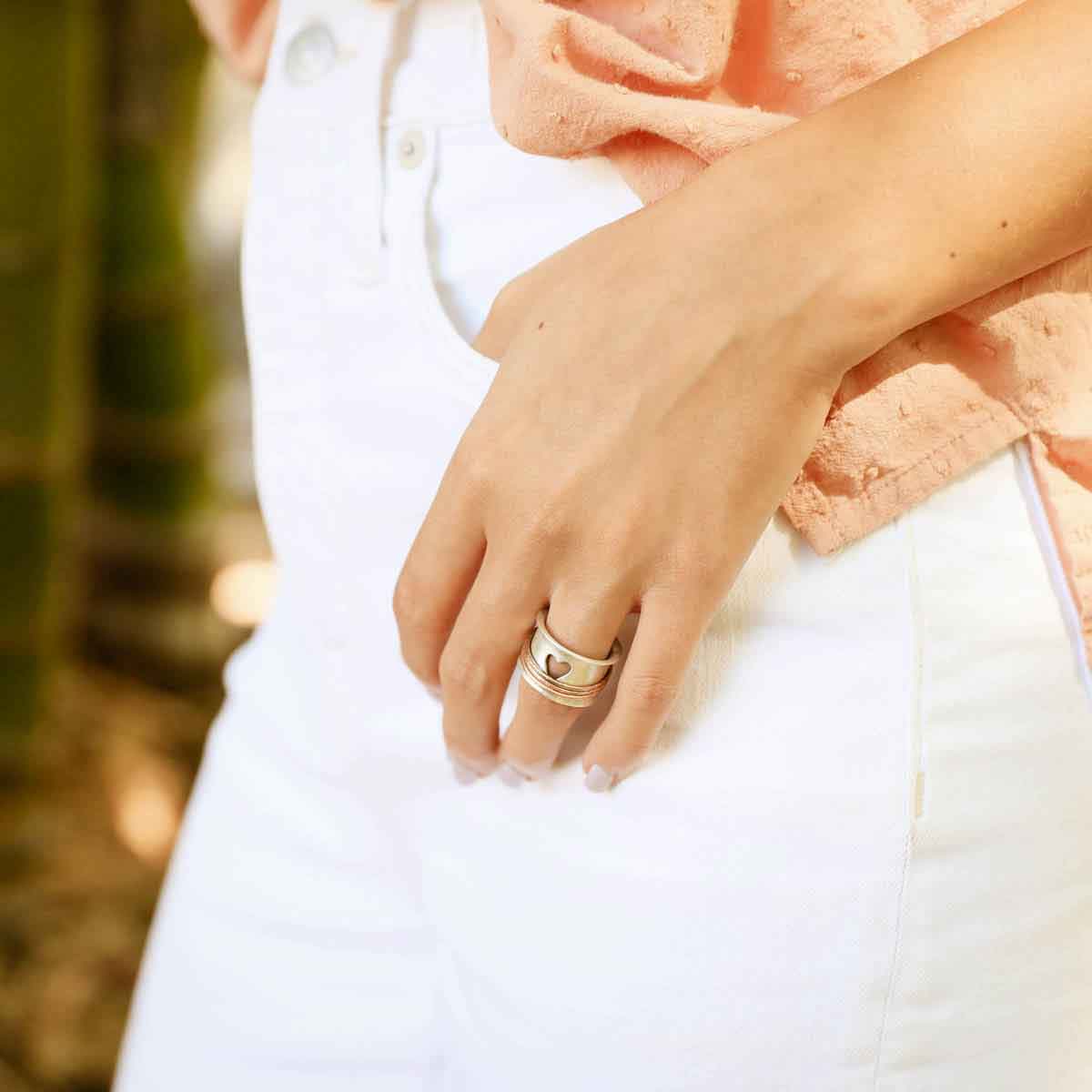 photo of girl wearing brave love® spinner ring {sterling silver & bronze} with her thumb in her pant pocket