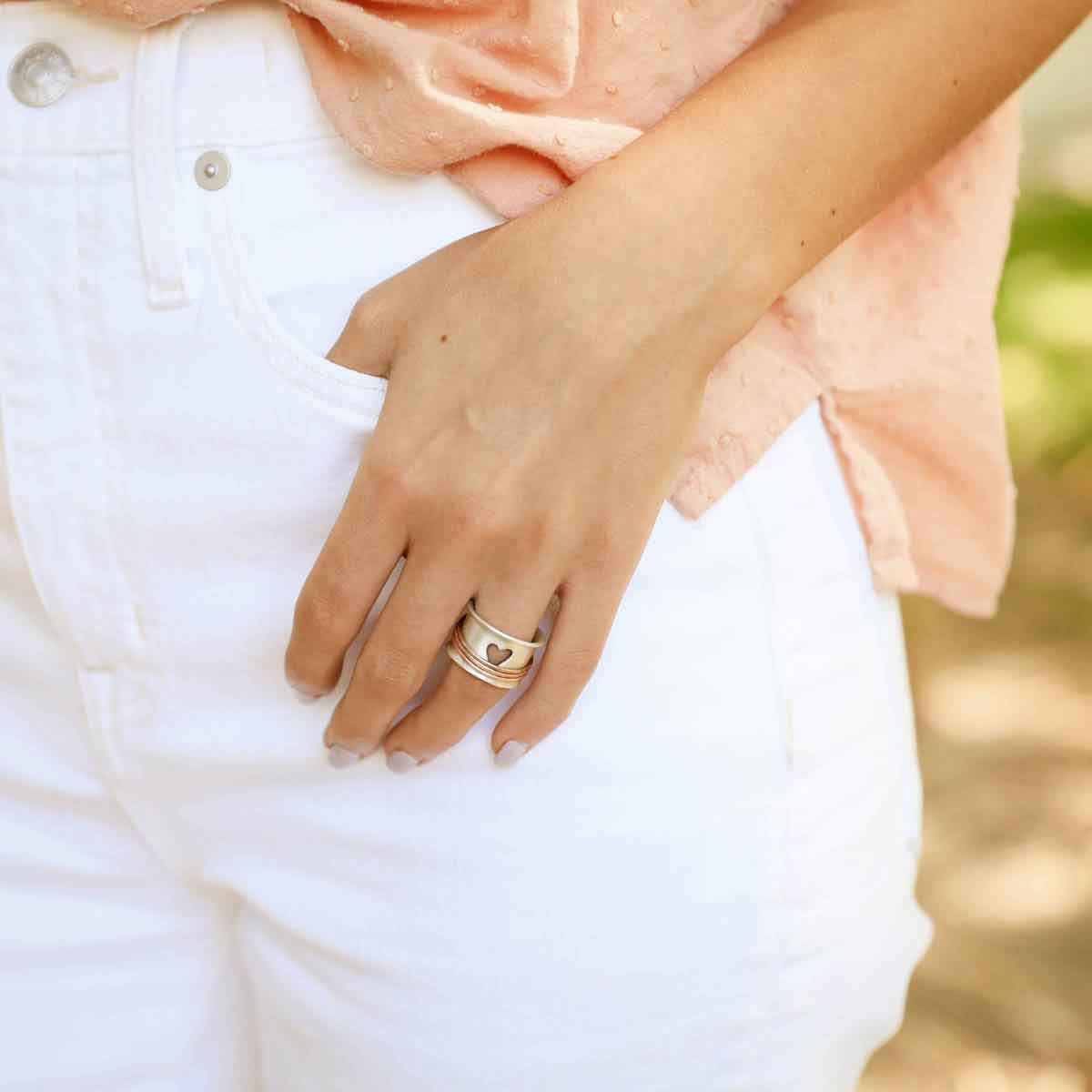 photo of girl wearing brave love® spinner ring {sterling silver & bronze} with her thumb in her pant pocket