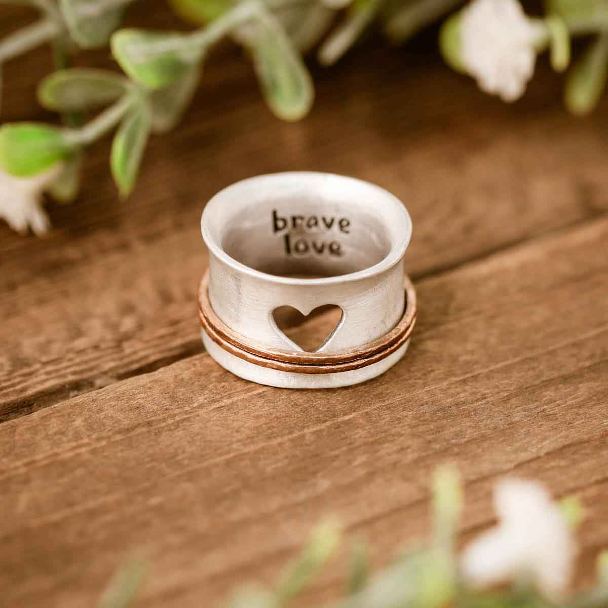 brave love® spinner ring {sterling silver & bronze} on wooden table