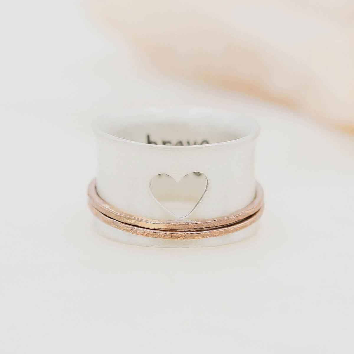 brave love® spinner ring {sterling silver & bronze} on marble background