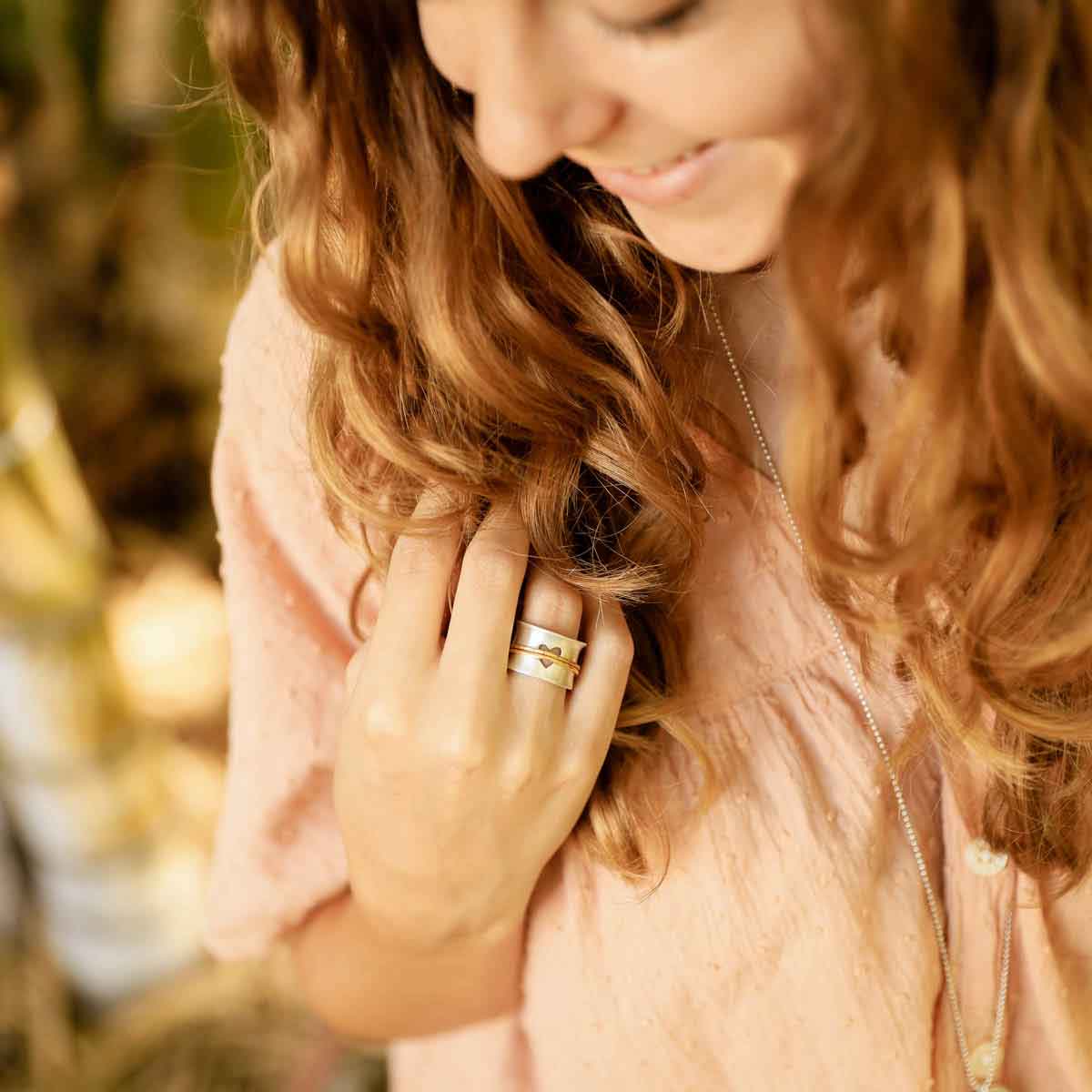 girl wearing brave love® spinner ring {sterling silver & 10k gold}