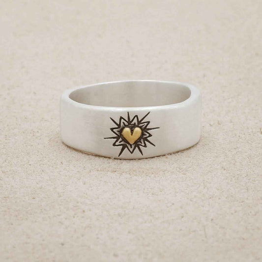 Bursting heart ring hand-molded sterling silver finished with a 10k yellow gold heart and hand-engraved with sunburst design