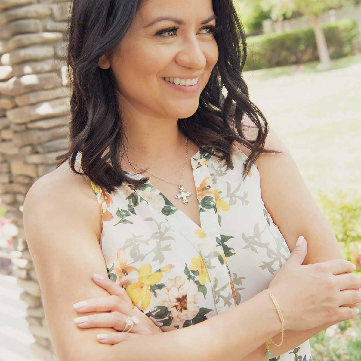 Woman wearing her handcrafted carry my heart 14k yellow gold bracelet with aventurine stone