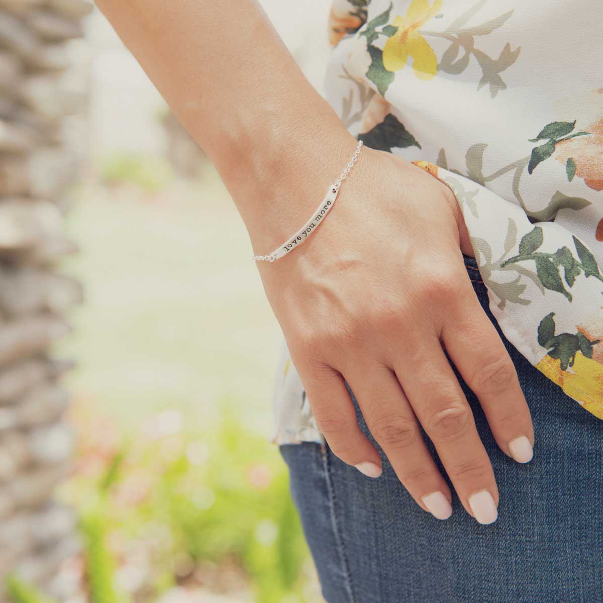 Woman wearing personalized sterling silver carry my heart bracelet