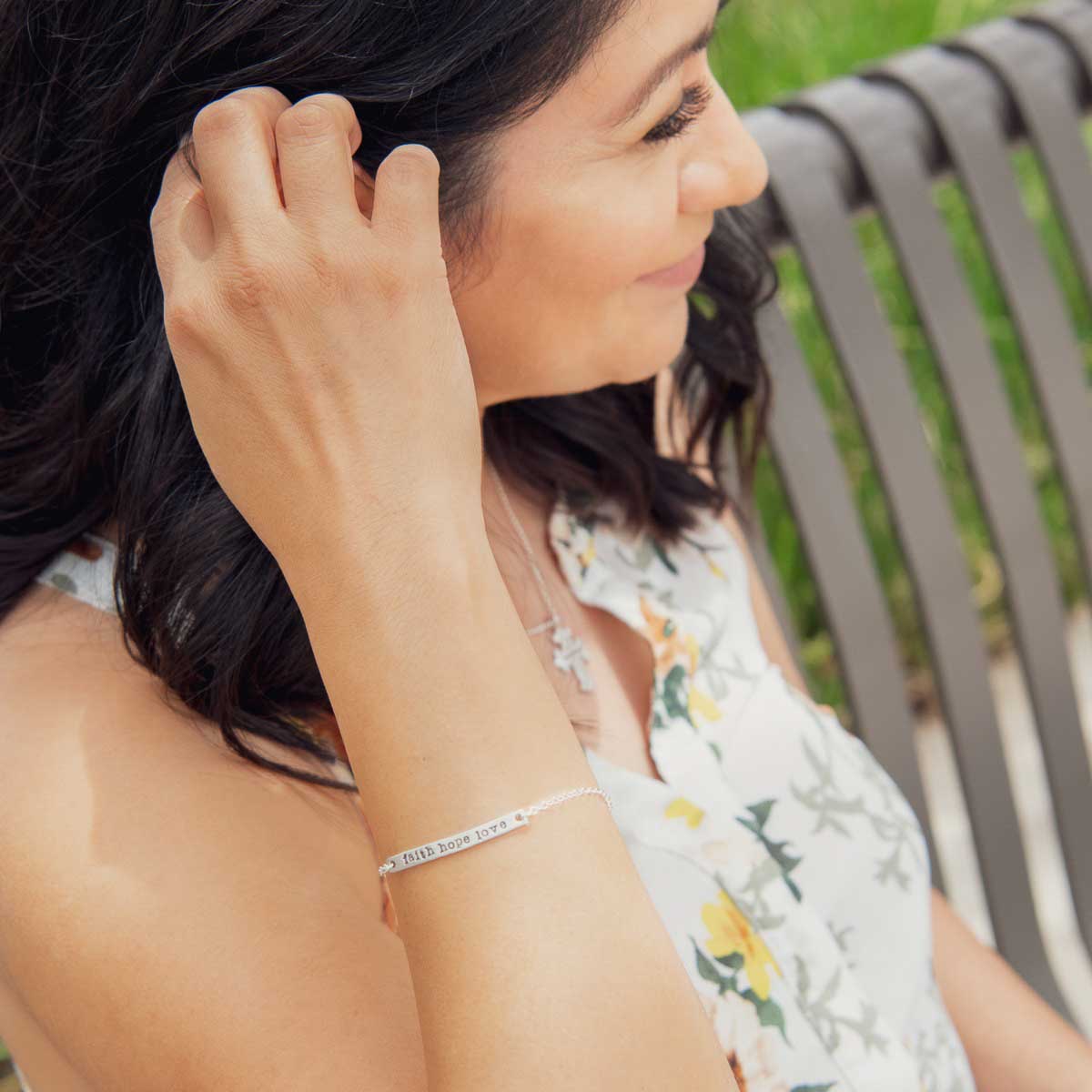 Woman wearing personalized sterling silver carry my heart bracelet