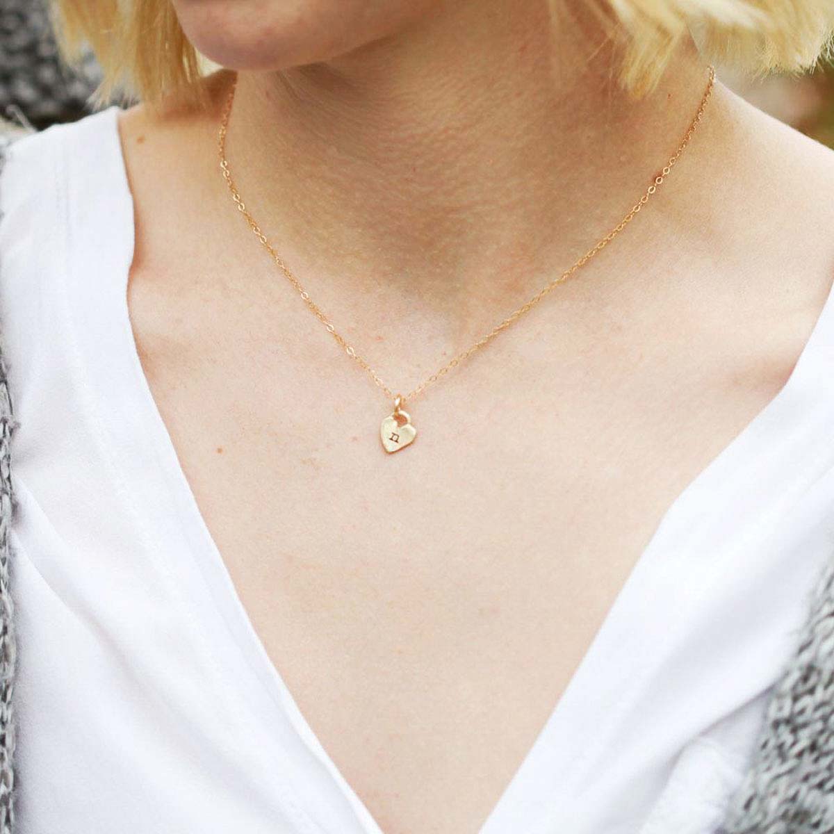 Woman wearing her Cherished hearts initials necklace handcrafted in 10k yellow gold including two customizable charms