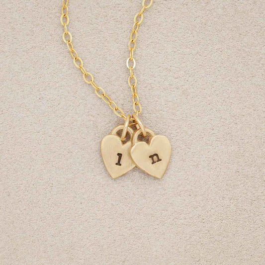 Cherished hearts initials necklace handcrafted in 14k yellow gold including two customizable charms