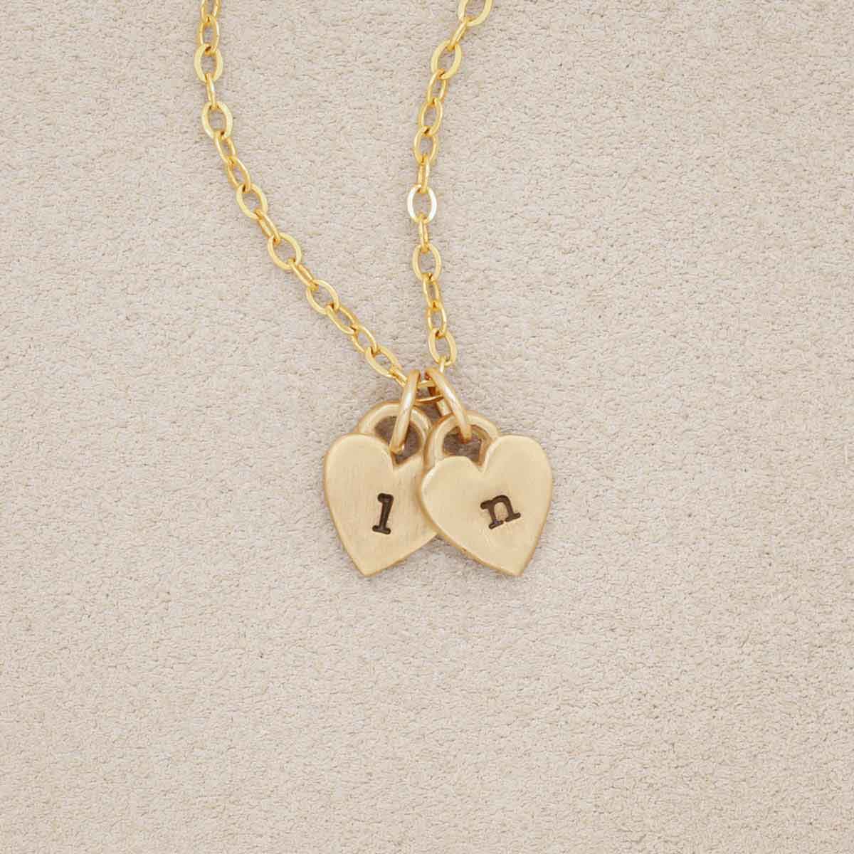 Cherished hearts initials necklace handcrafted in 10k yellow gold including two customizable charms