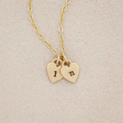 Cherished hearts initials necklace handcrafted in 10k yellow gold including two customizable charms