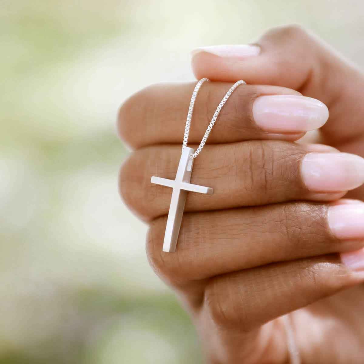 woman wearing sterling silver child of faith cross necklace