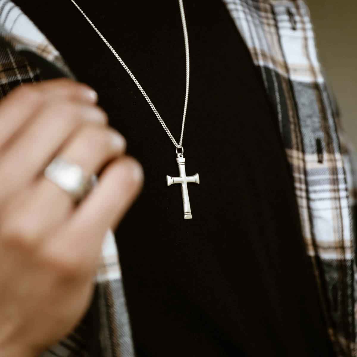 man wearing a sterling silver Chosen Cross Necklace