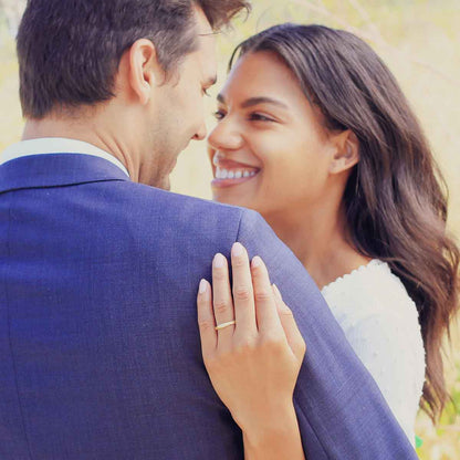 Girl wearing Classic stacking ring hand-molded and cast in 10k yellow gold with a 2mm birthstone or diamond with her husband