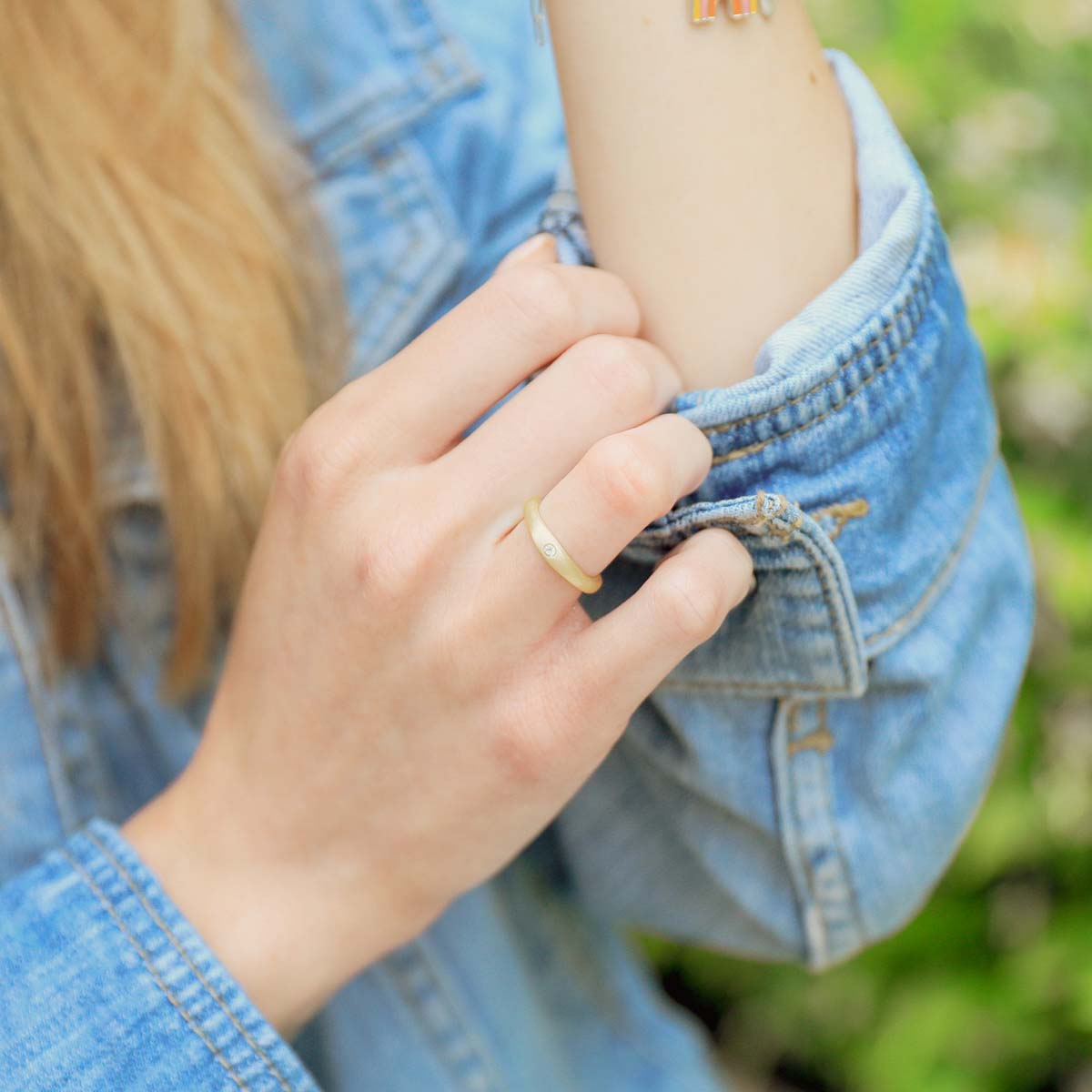 Girl wearing Classic stacking ring hand-molded and cast in 10k yellow gold with a 2mm birthstone or diamond 