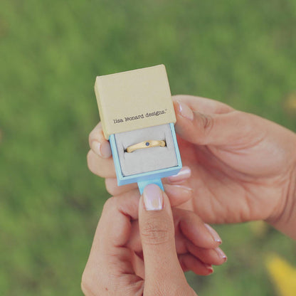 Classic stacking ring hand-molded and cast in 10k yellow gold with a 2mm birthstone or diamond in original packaging