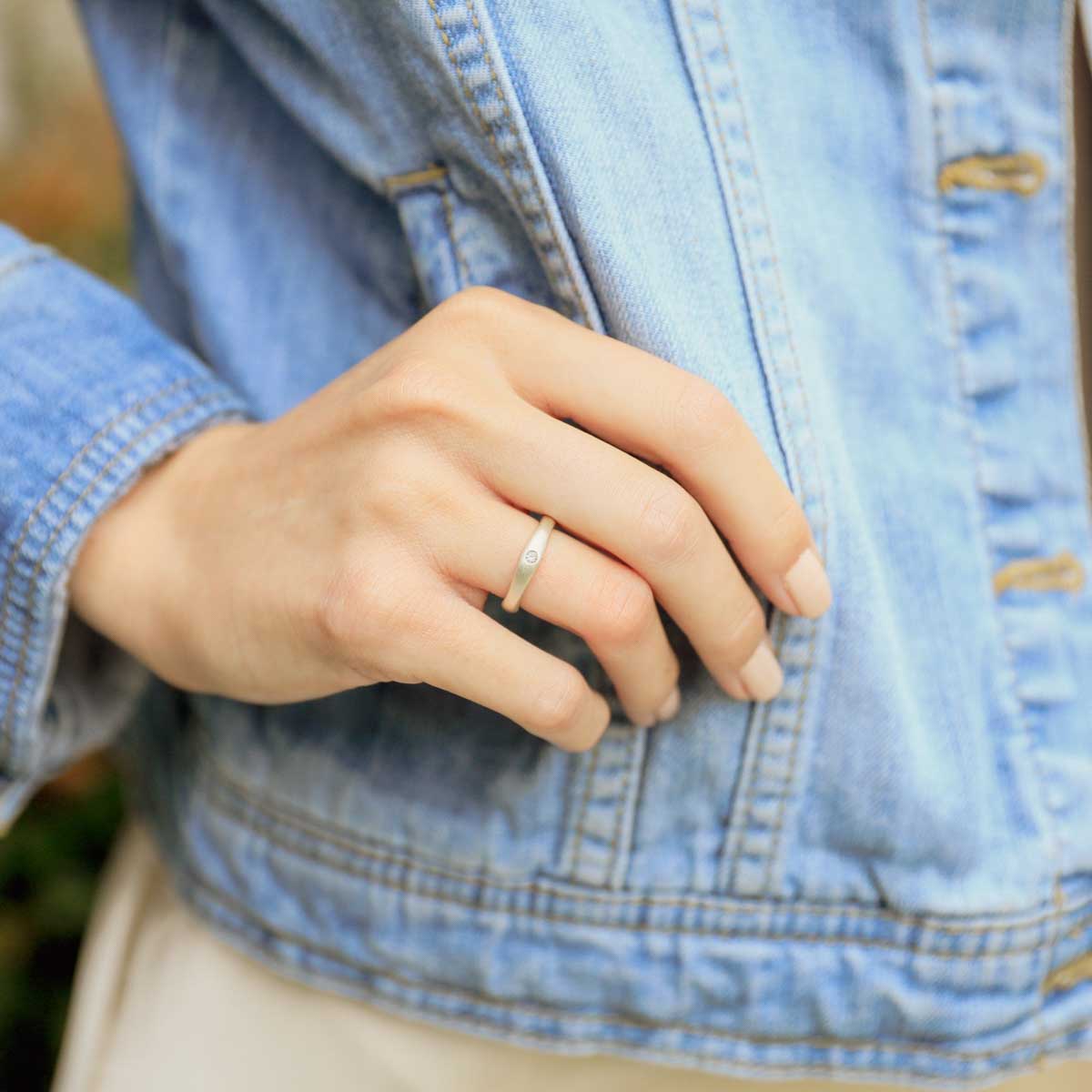 Girl wearing Classic stacking ring hand-molded and cast in sterling silver with a 2mm birthstone or diamond