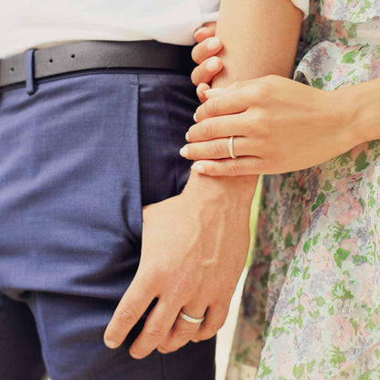 Girl wearing Classic stacking ring hand-molded and cast in sterling silver with a 2mm birthstone or diamond with her husband