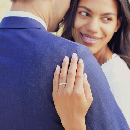 Girl wearing Classic stacking ring hand-molded and cast in sterling silver with a 2mm birthstone or diamond with her husband