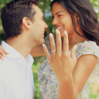 Girl wearing Classic stacking ring hand-molded and cast in sterling silver with a 2mm birthstone or diamond with her husband