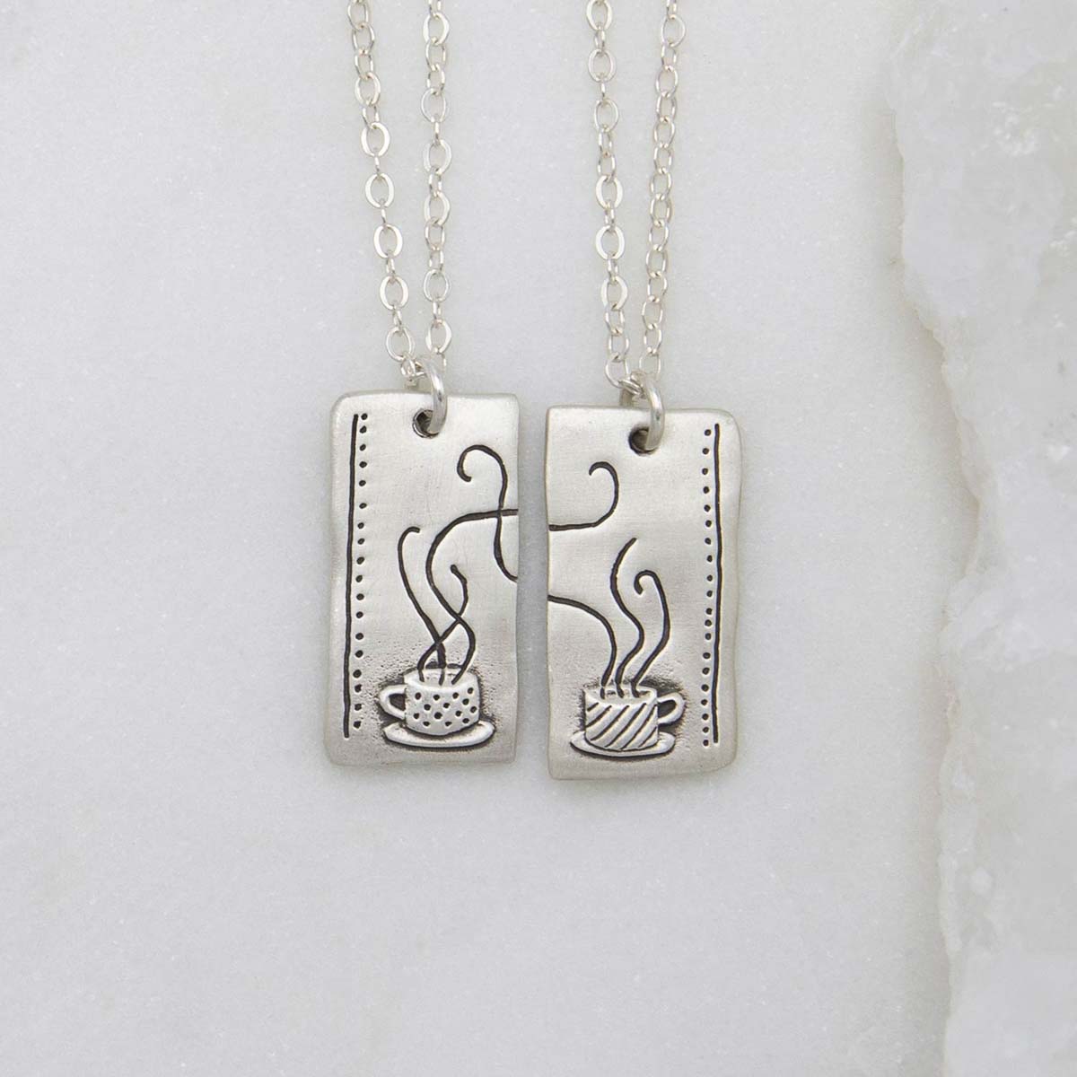 Coffee and tea necklace set handcrafted in sterling silver with a matte brushed finish with engravings to be connected and shared with someone