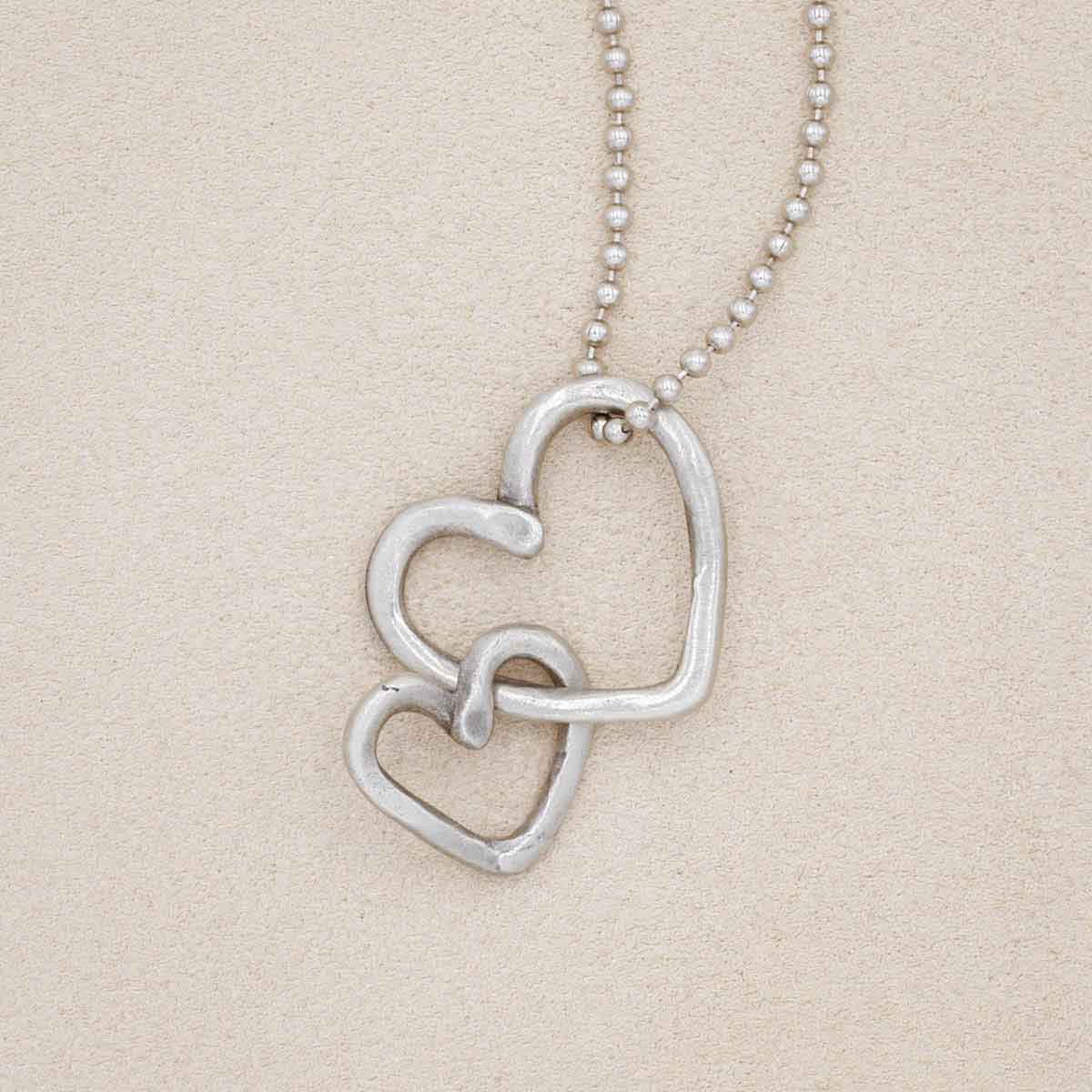 Connected hearts necklace handcrafted in pewter including a pair of heart charms