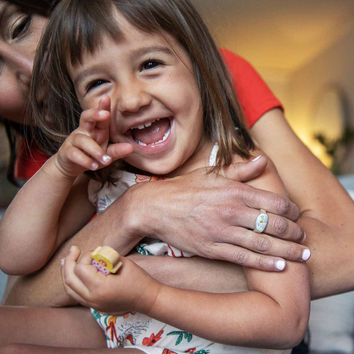 Mom wearing Constellation ring handcrafted in sterling silver set with birthstones and crystal gemstones and with her daughter