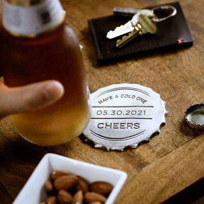 close up of the Crafting Memories Coaster Set on a slate table with a bottle and almond snacks