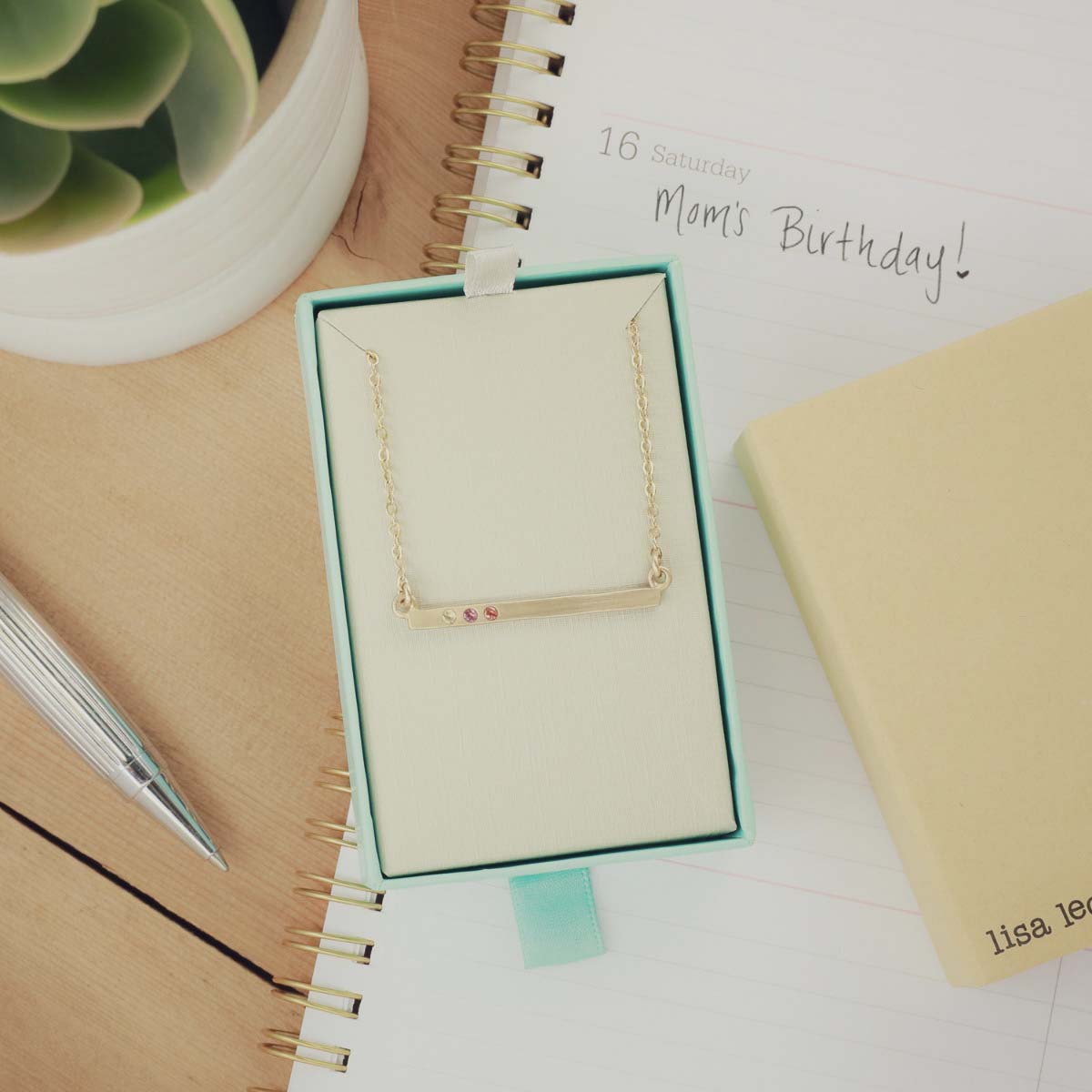 14k yellow gold cross bar birthstone necklace strung on a gold-filled link chain customizable with up to 7 genuine 2mm birthstones in original packaging