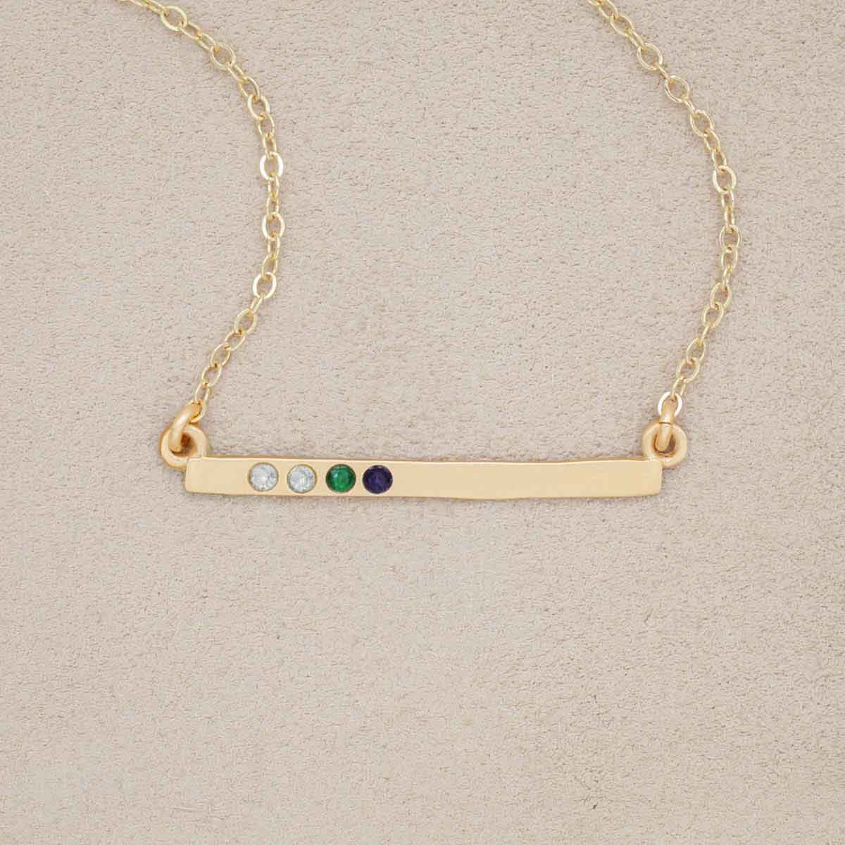 10k yellow gold cross bar birthstone necklace strung on a gold-filled link chain customizable with up to 7 genuine 2mm birthstones