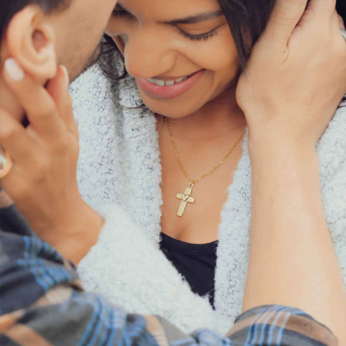 girl wearing her Handcrafted 10k yellow gold cross of faith necklace strung on a gold-filled link chain