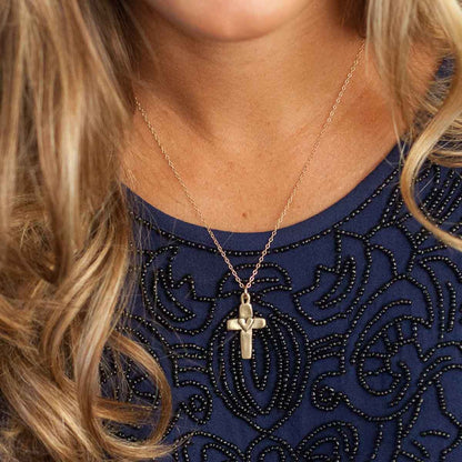 girl wearing her Handcrafted 14k yellow gold cross of faith necklace strung on a gold-filled link chain