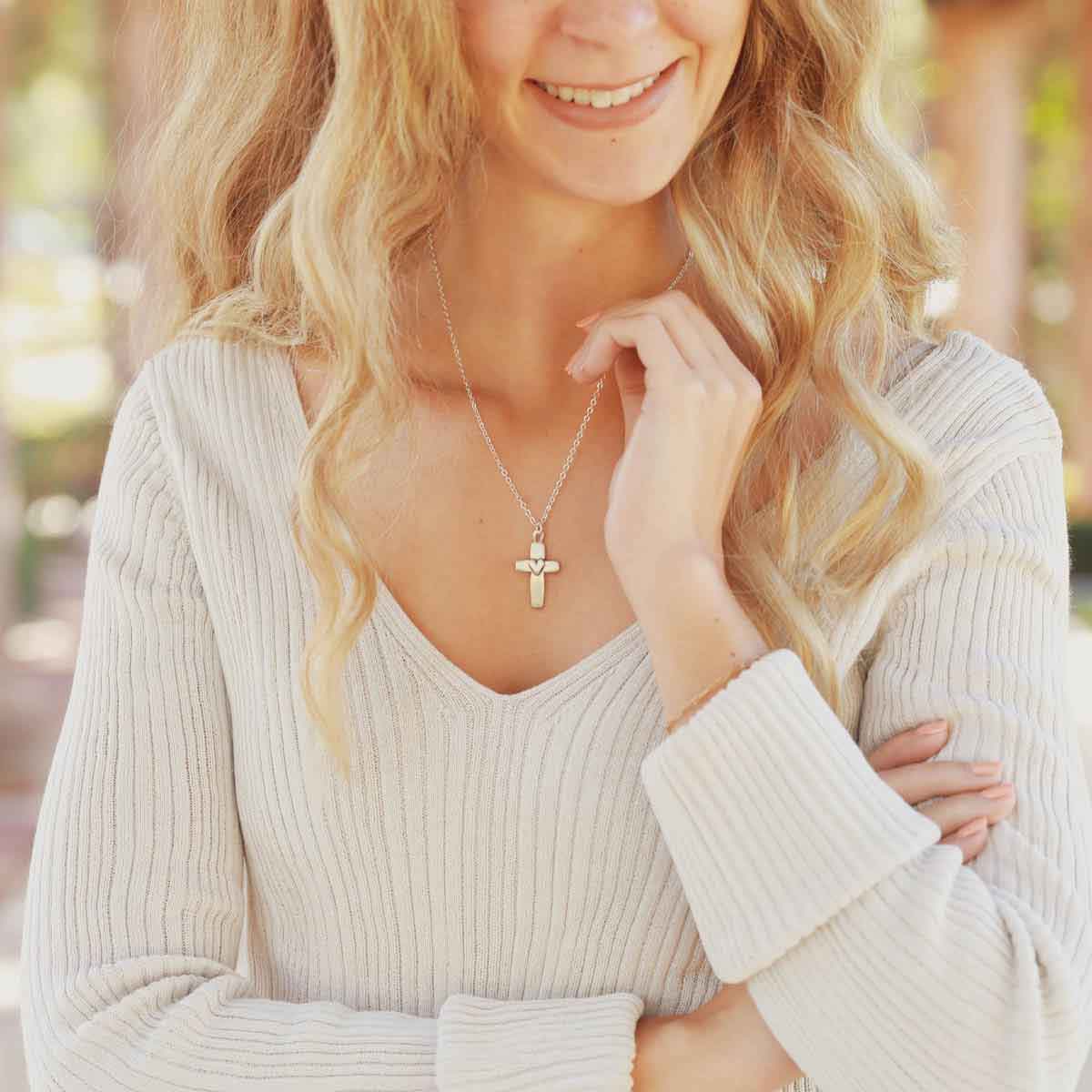 girl wearing a sterling silver cross of faith necklace