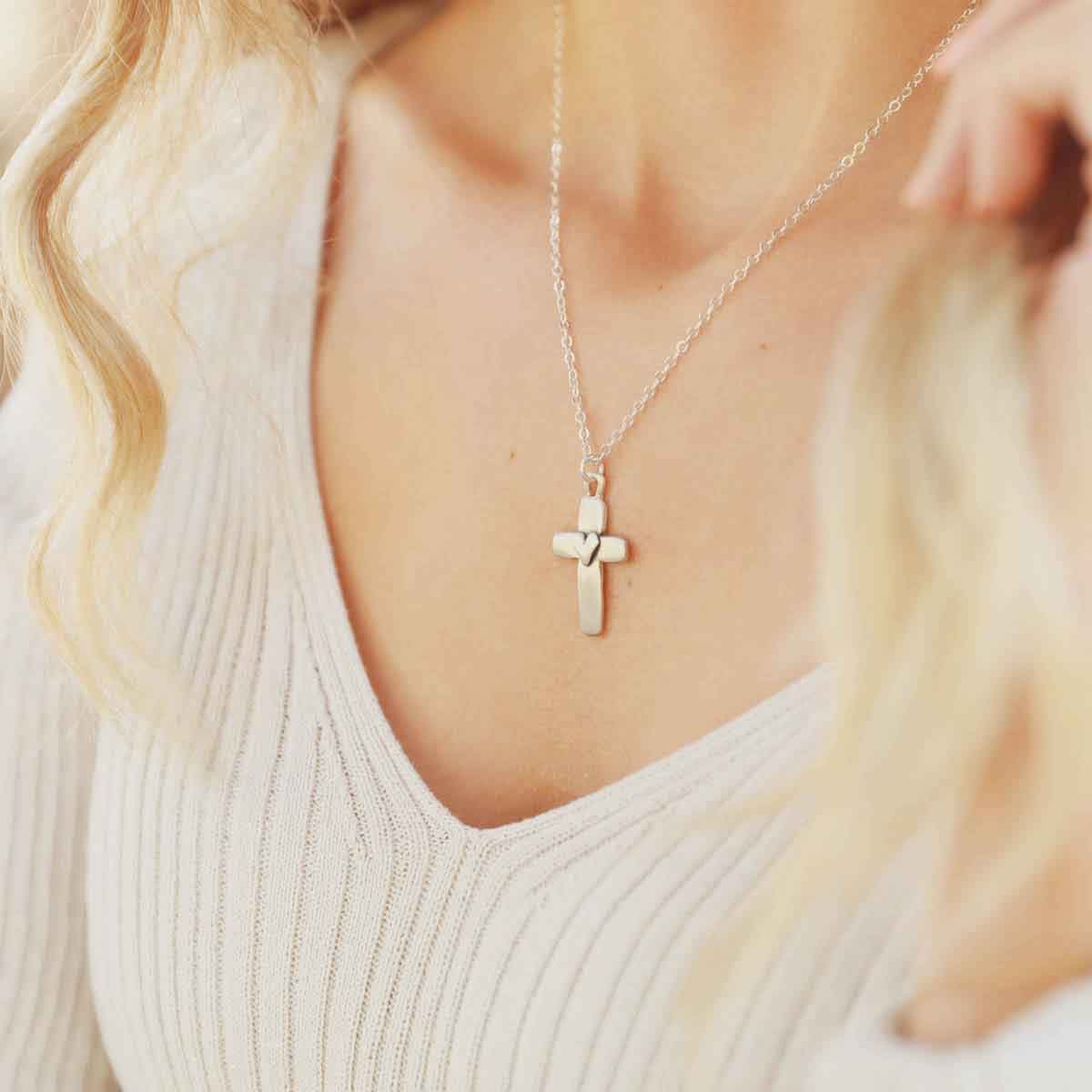 girl wearing a sterling silver cross of faith necklace