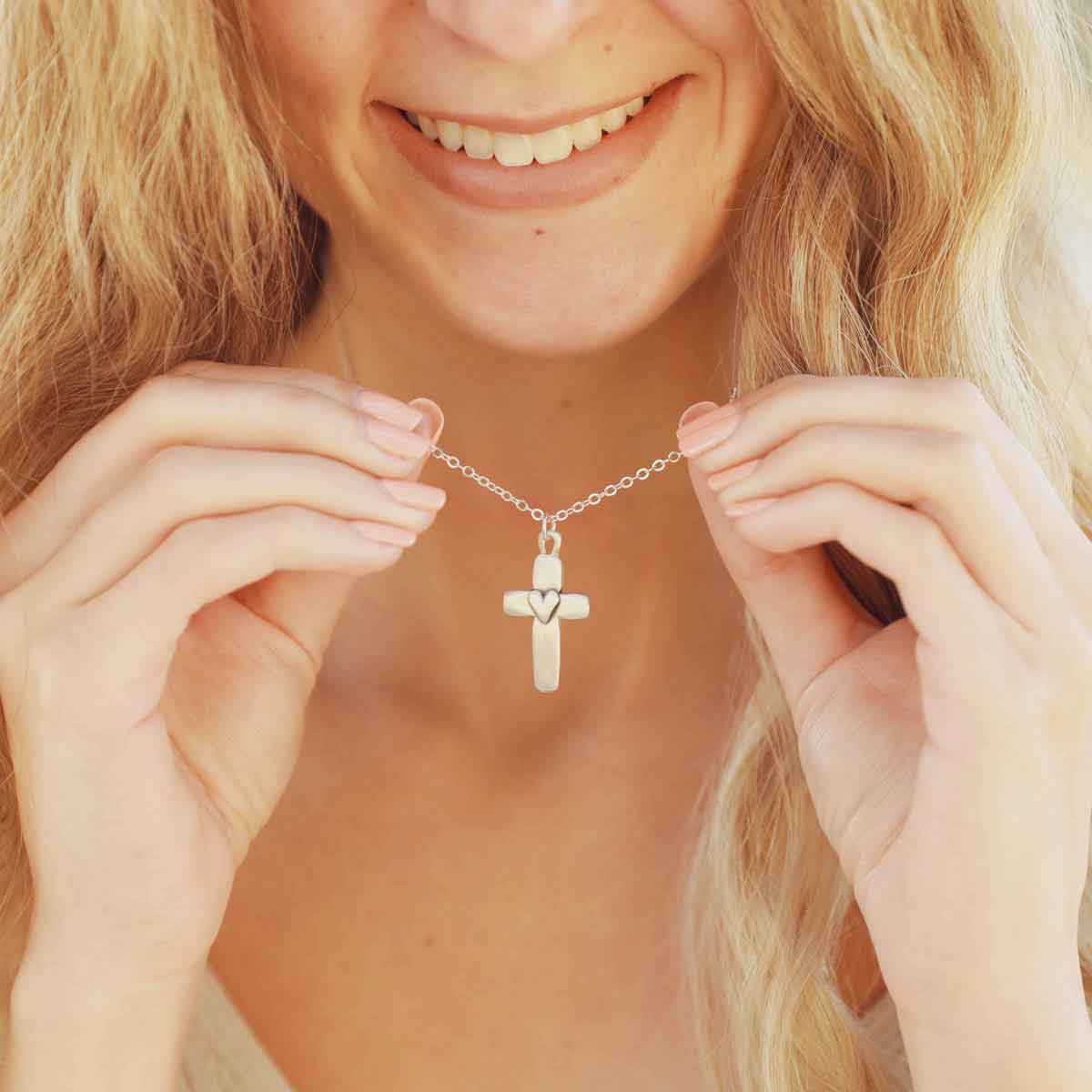 girl wearing a sterling silver cross of faith necklace