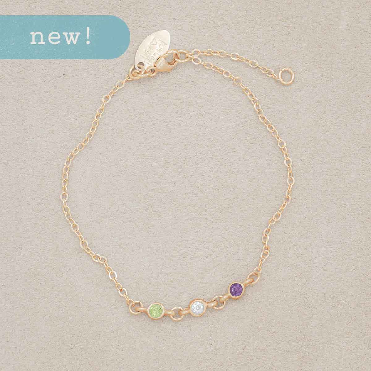 mom wearing 10k yellow gold Dainty Finespun Birthstone Bracelet - Medium personalized with 3mm birthstone