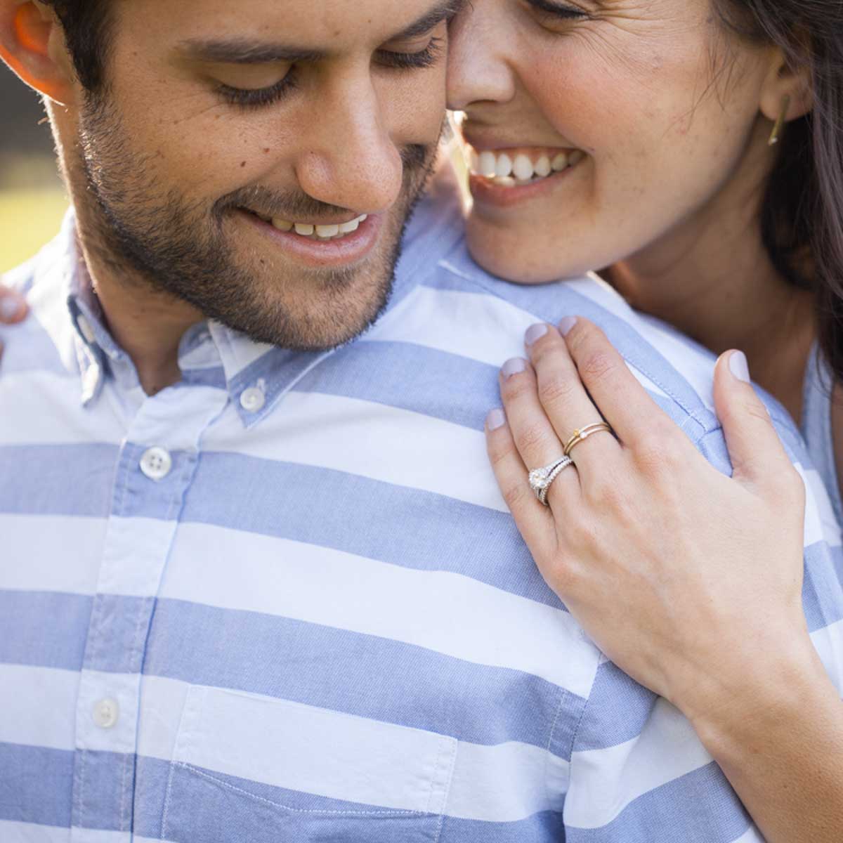 girl wearing her pair of 10k yellow gold Dainty finespun birthstone ring with a genuine birthstone or conflict free diamond next to her husband