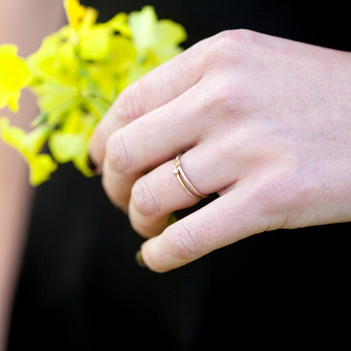 girl wearing her pair of Handcrafted 14k yellow gold Dainty finespun birthstone ring with a genuine birthstone or conflict free diamond