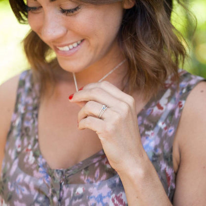 girl wearing her pair of sterling silver Dainty finespun birthstone ring with a genuine birthstone or conflict free diamond with other sterling silver jewelry