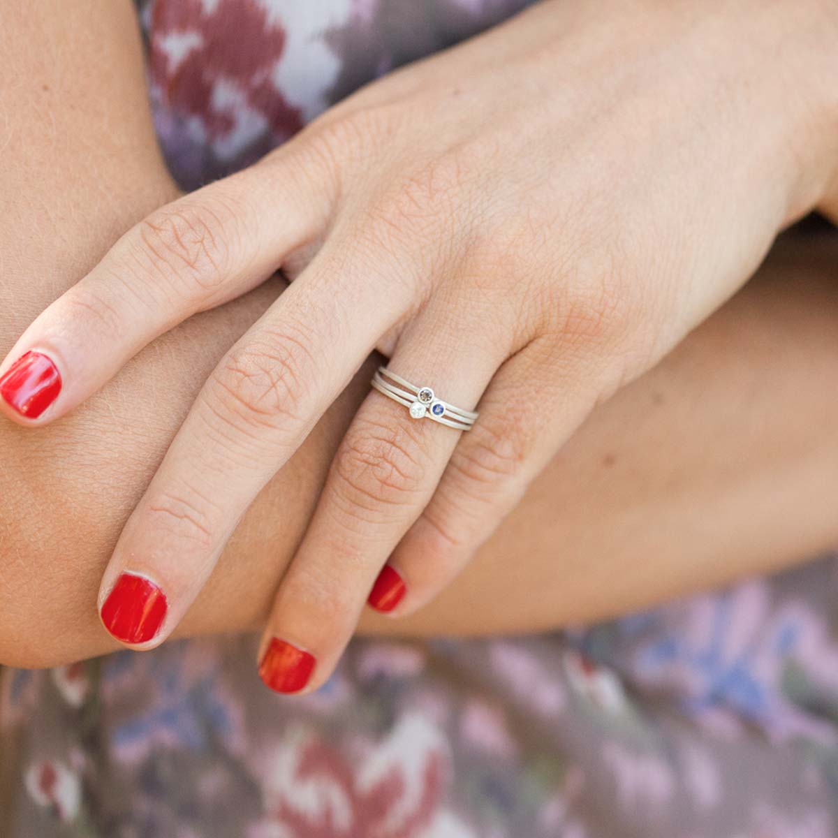 Girl wearing Dainty finespun ring trio handcrafted in sterling silver set with 3 birthstones