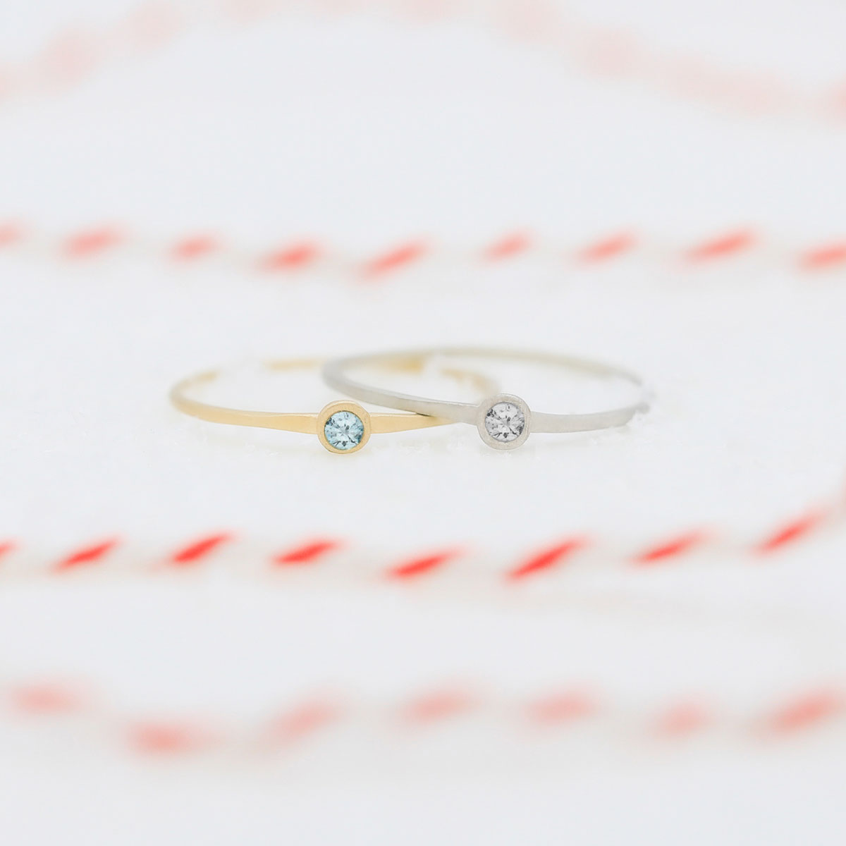 sterling silver and yellow gold dainty finespun birthstone rings with striped ribbon