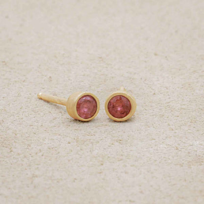 10k yellow gold Dainty Finespun Birthstone Stud Earrings - Medium 3mm on beige background