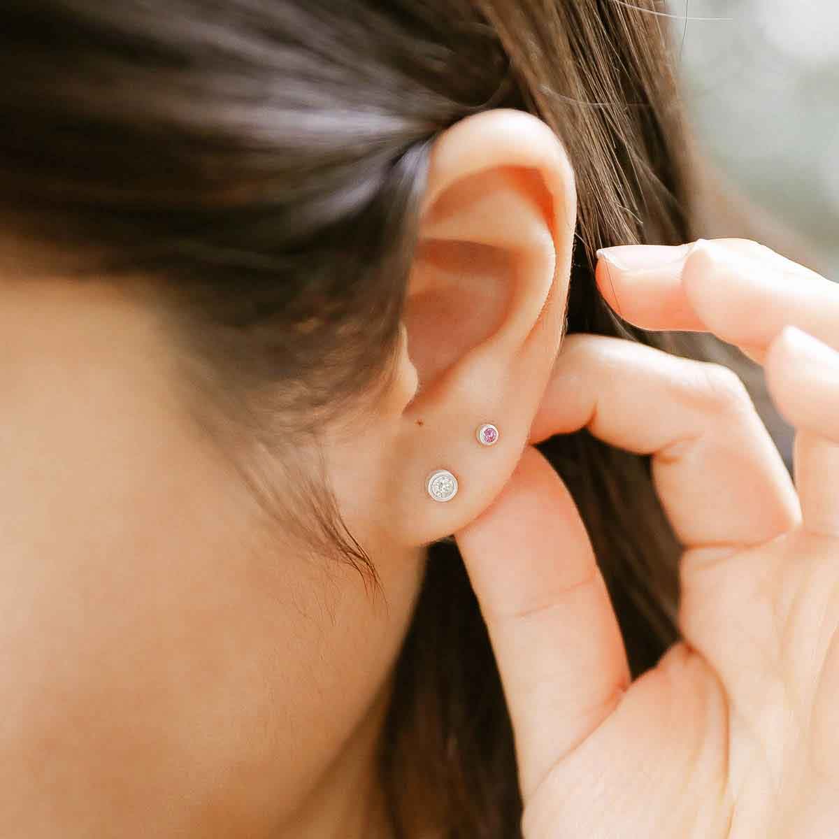 girl wearing 2mm Dainty Finespun Birthstone Stud Earrings - Small in sterling silver