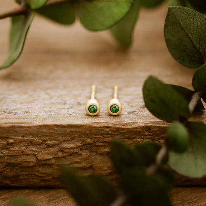 10K yellow gold Dainty Finespun Birthstone Stud Earrings - Small 2mm on a wood background