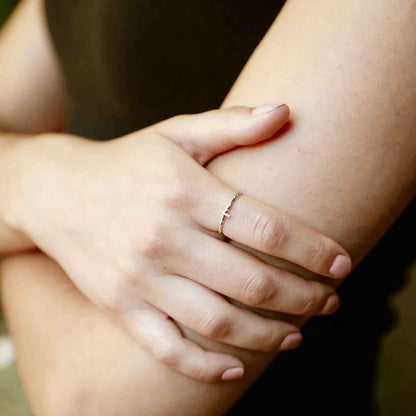 woman holding a sterling silver Dainty Rugged Cross Ring