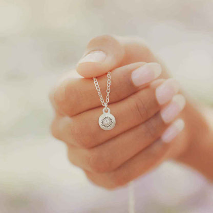 girl wearing a Dainty Sunburst Necklace cast in Sterling Silver and set with a 3mm cubic zirconia stone