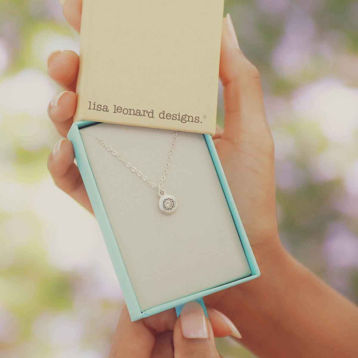 girl wearing a Dainty Sunburst Necklace cast in Sterling Silver and set with a 3mm cubic zirconia stone